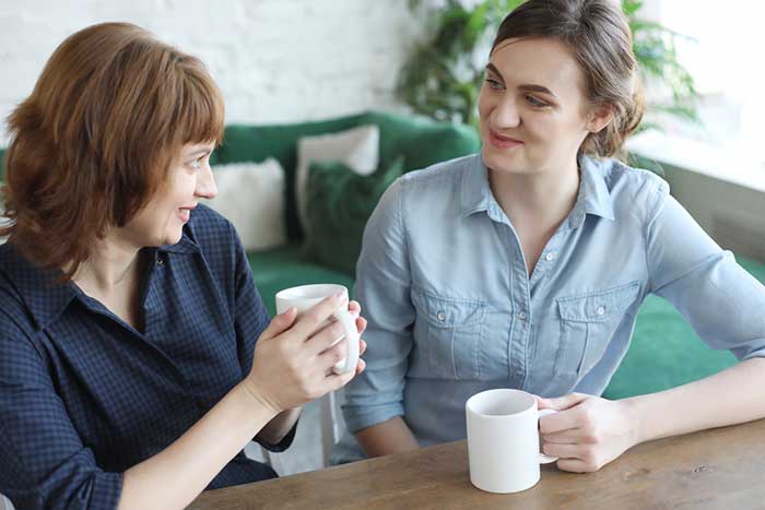 Mother and adult daughter talking